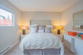 a white bedroom with a bed and a window at Sunnyvale Crossings Apartments, LLC, Sunnyvale, 94087