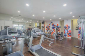a gym with cardio equipment and mirrors in a building at Sunnyvale Crossings Apartments, LLC, California, 94087