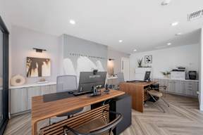 A modern office space with a wooden desk and chairs at Latitude Apartments at Mission Valley Apartments, San Diego, CA, 92120