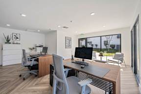 A modern office with a wooden desk and a computer monitor at Latitude Apartments at Mission Valley Apartments, San Diego, California