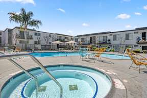 A swimming pool with a metal ladder in the middle of it at Latitude Apartments at Mission Valley Apartments, San Diego, CA