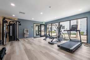 A gym with treadmills, exercise bikes, and other equipment at Latitude Apartments at Mission Valley Apartments, San Diego, California