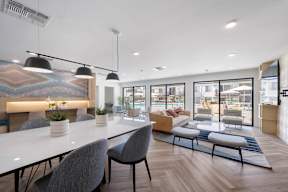 A modern dining area with a long table and chairs at Latitude Apartments at Mission Valley Apartments, San Diego