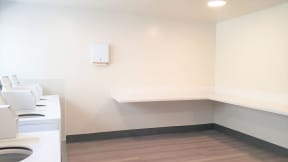 a laundry room with a washing machine and a shelf at Citra Apartments LLC, San Diego, CA, 92107
