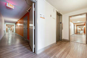a hallway with wood floors and white walls and open doors at Citra Apartments LLC, San Diego, CA, 92107