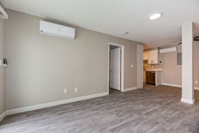 an empty living room with a door to a kitchen at Citra Apartments LLC, California