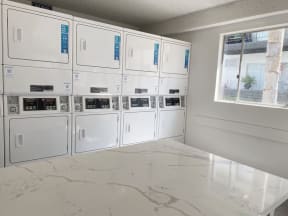 a bunch of white appliances in a room at Latitude Apartments at Mission Valley, San Diego