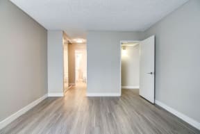 an empty living room with white walls and wood floors at La Jolla Blue, San Diego, CA 92122 