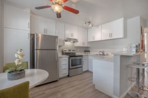 a kitchen with blue and red lights on the ceiling and white counters at Napa Green Apartments LLC, California, 94559