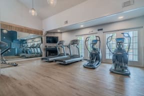 a gym with cardio machines and a fireplace at Napa Green Apartments LLC, Napa, 94559