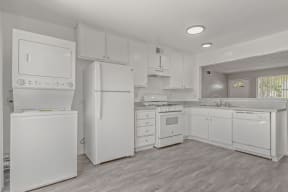 a white kitchen with white appliances and white cabinets at Ocean Villas, California, 93033