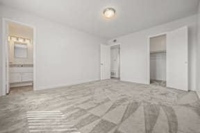 an empty living room with white walls and a bathroom at Ocean Villas, California