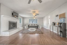 a living room with a fireplace and a ceiling fan at Ocean Villas, Oxnard