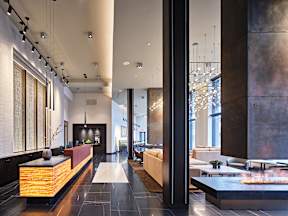 A modern lobby with a reception desk and a large window.