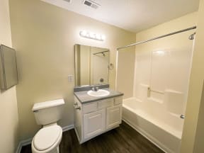 apartment bathroom with toilet sink and shower