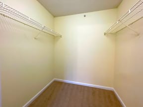 an empty room with a closet and a wall with a hanging rack