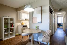 A dining room with a table and chairs.