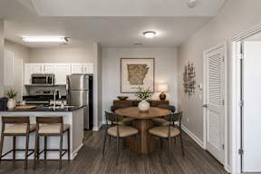 A kitchen with a table and chairs in the middle of the room.