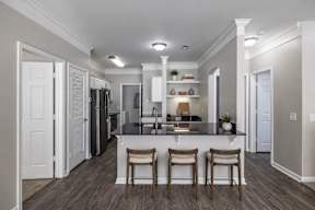 A kitchen with a bar stool and a counter.
