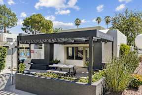 A modern house with a black and white exterior and a patio area.