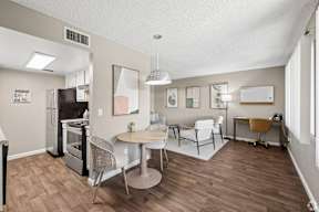 A kitchen with a table and chairs in the middle of the room.