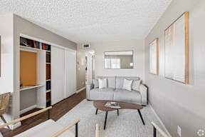 A living room with a grey couch and a coffee table.