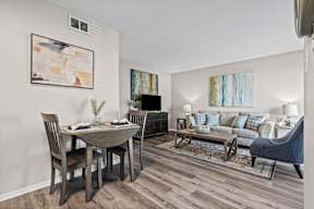 A modern living room with a dining table and a couch.