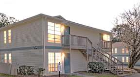 A two story building with a staircase leading to the second story.