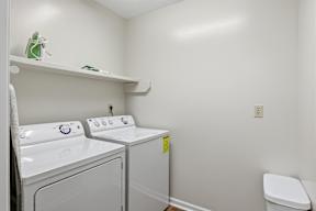 A small laundry room with a washer and dryer.