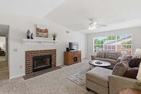A living room with a fireplace and a couch.
