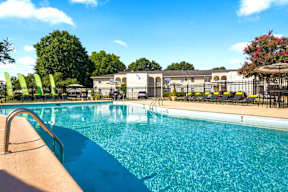 A swimming pool with a metal ladder and a metal fence.