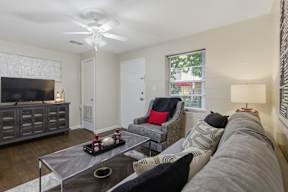 A living room with a grey couch and a television.
