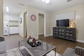 A living room with a grey coffee table and a grey sofa.
