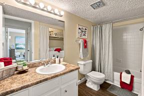 A bathroom with a sink, toilet, and shower.