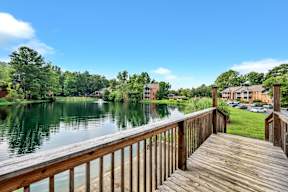 a view of a body of water from a wooden deck
