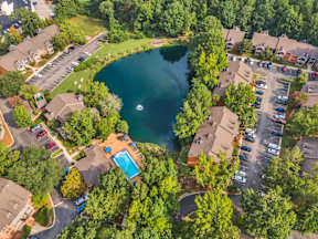 an aerial view of a neighborhood with a lake and houses