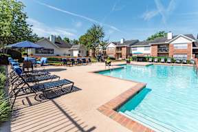 our apartments offer a swimming pool with lounge chairs and umbrellas