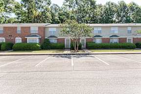 an empty parking lot in front of an apartment building