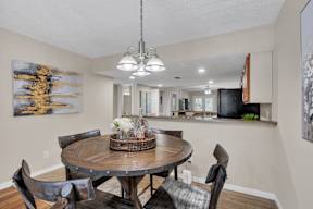 a dining room with a table and chairs and a kitchen
