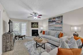 a living room with a couch and a ceiling fan
