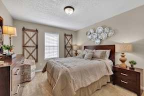 a bedroom with a bed and a dresser and a window