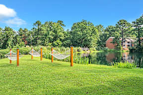 a hammock on the grass near a body of water