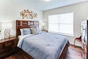 a bedroom with a large bed and a large window