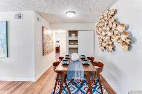 a dining room with a wooden table and chairs