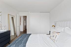 a bedroom with a large bed and a closet