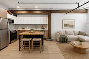 A modern kitchen with a wooden table and chairs.