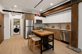A kitchen with a wooden table and chairs.