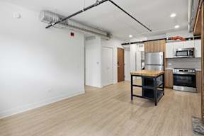 A kitchen area with a stove, oven, and microwave.