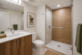 A bathroom with a toilet, sink, and shower.