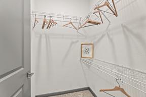 A row of clothes hangers on a rack in a room at The Preserve at Preston Trails Apartments, Cedar Hill